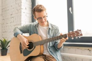 Man playing guitar for video message